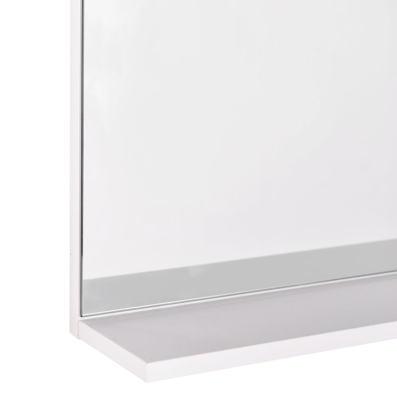 Close-up of the mirror's bottom shelf ledge and glass edge finish