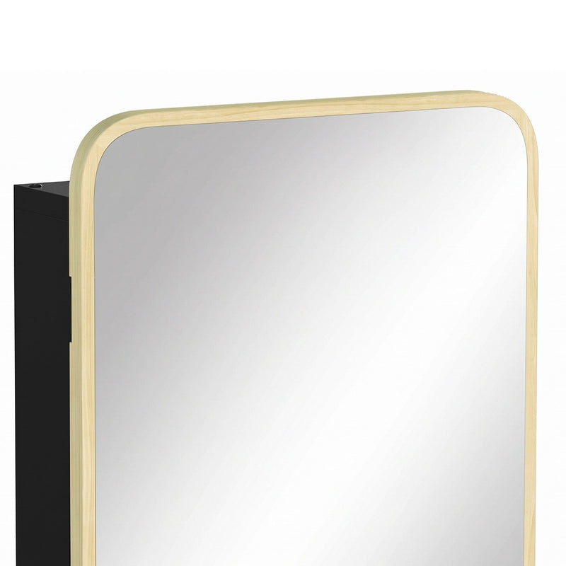 Close-up of the rounded natural wood mirror frame and black cabinet side