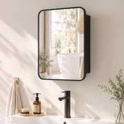 Black mirror cabinet mounted on a bathroom wall above a basin