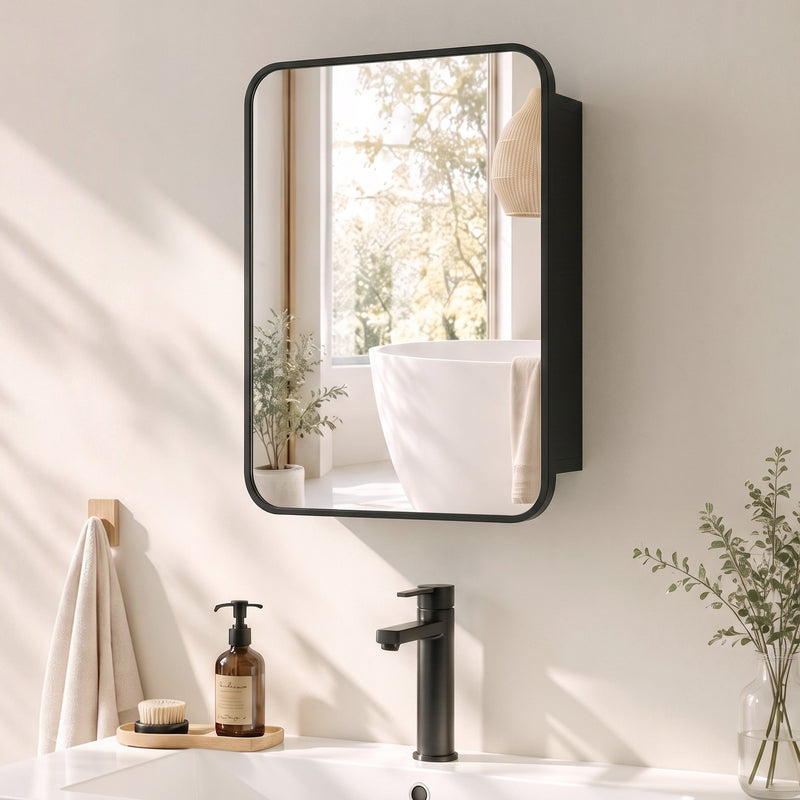 Black mirror cabinet mounted on a bathroom wall above a basin