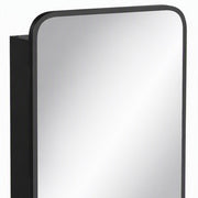Close-up of the rounded black mirror frame and cabinet side
