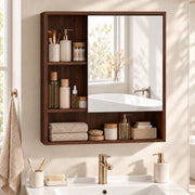 Walnut brown wall-mounted mirror cabinet styled with towels and toiletries above a vanity with gold taps