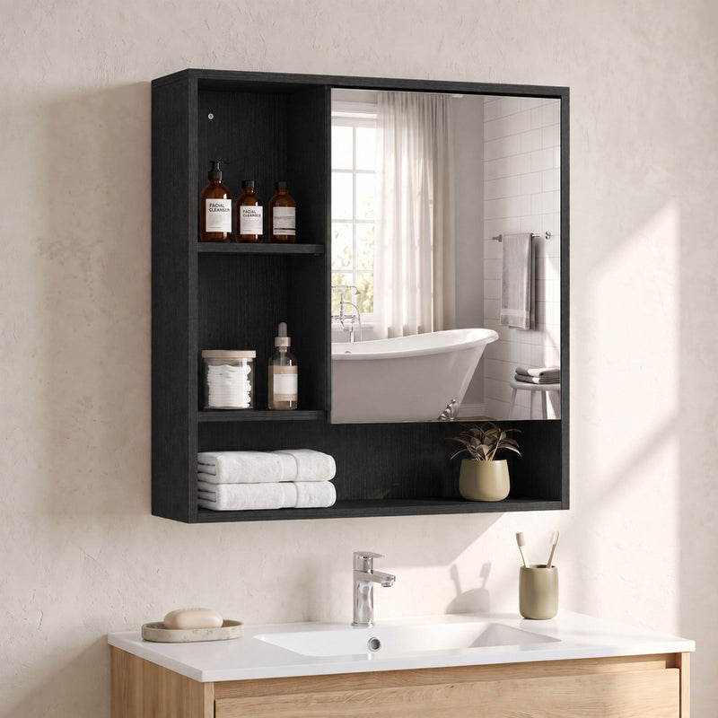 Black mirror cabinet with bottles and folded towels on the wall of a bathroom with a freestanding bath