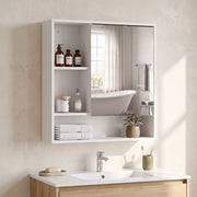 White mirror cabinet in a bathroom with a mirror reflecting a bathtub
