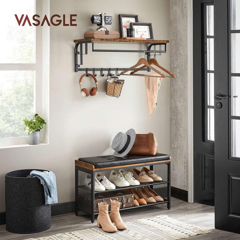 Coat rack fitted in a hallway above a shoe bench, holding hangers, headphones and a bag