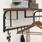 Close-up of the shelf edge, hanging rail and hooks holding a hanger and umbrella