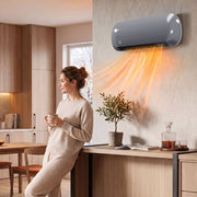 Grey wall heater running in an open plan kitchen and dining area while a woman holds a mug