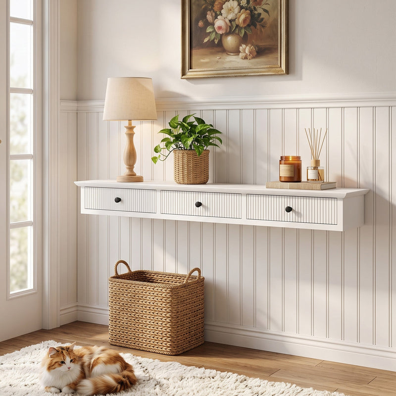 White hallway shelf on a panelled wall with a table lamp, plant and candle arranged on top