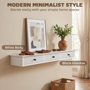 White shelf with labels pointing out the white body and black handles, styled with framed art