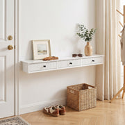 White shelf beside a front door with a photo frame and vase, trainers and basket below