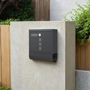 The same mailbox mounted on a stone gate pillar with planting either side