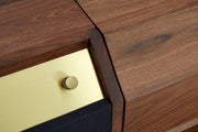 Macro detail of the brass-finished handle on the sideboard