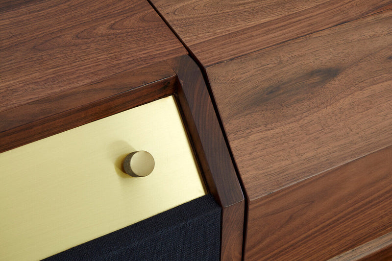 Macro detail of the brass-finished handle on the sideboard