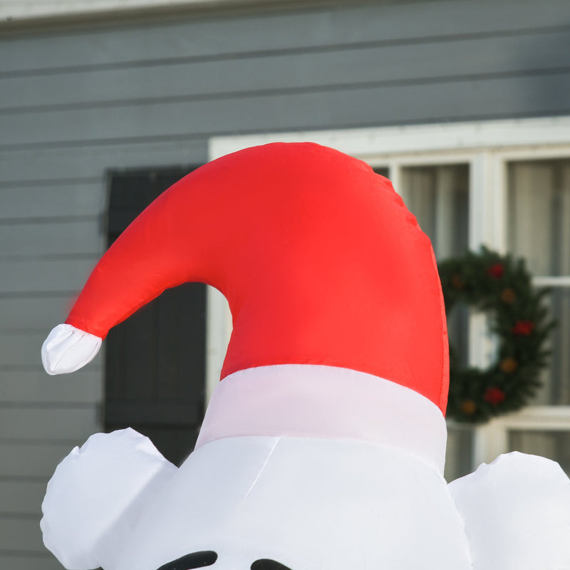 Close-up of the bear's Santa hat beside a window and wreath