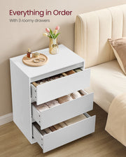 White chest of drawers with all 3 drawers open showing folded clothes inside