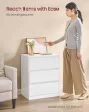Woman reaching for a cup on top of the chest of drawers beside a sofa