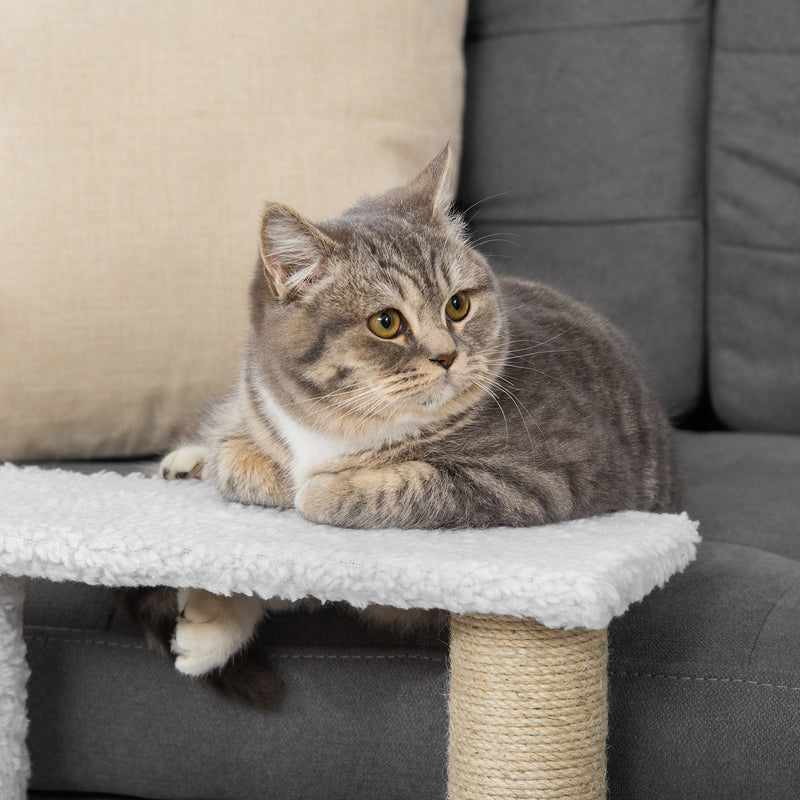Close-up of a tabby cat lying on the top plush step of the stairs