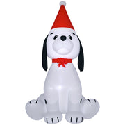White inflatable puppy dog with black ears, a red Santa hat and a red bow on a white background
