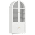 White arched tall pantry cabinet with acrylic upper doors and solid lower doors on a plain background