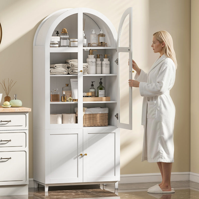 Woman in a robe opening the cabinet door to towels and toiletries on the shelves