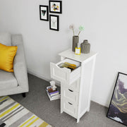 White 4 drawer cabinet beside a sofa in a living room with one drawer open