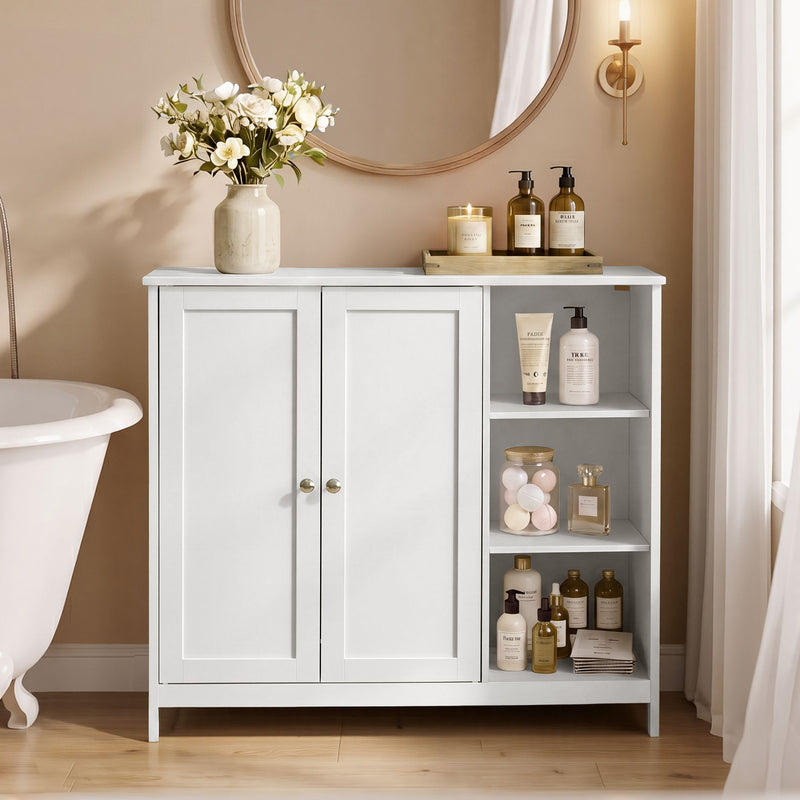 White 2-door bathroom floor cabinet with open side shelves, styled with flowers and toiletries