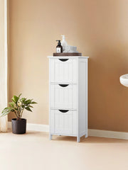 White bathroom cabinet styled beside a sink with a wash bag on top