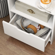 Bedside table drawer pulled open showing headphones and small items inside