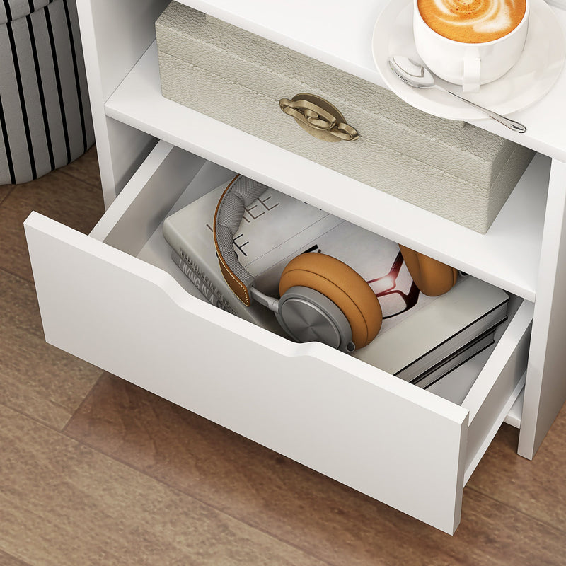 Bedside table drawer pulled open showing headphones and small items inside