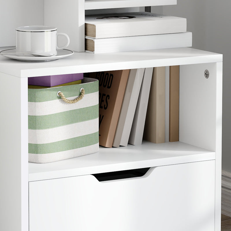 Close-up of the open compartment holding books and a striped storage basket