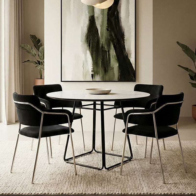 White ceramic marble effect round dining table seating 4 in a bright kitchen