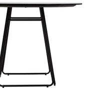 Close-up of the black finish on the tapered metal base of the dining table