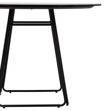 Close-up of the black finish on the tapered metal base of the dining table