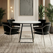 Round ceramic dining table styled with upholstered chairs and a pendant light above