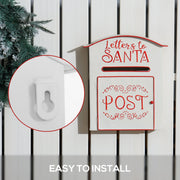 White Santa postbox on a white fence with a close-up of the keyhole wall hanger