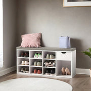 White entryway bench styled in a hallway with shoes stored in the cubbies