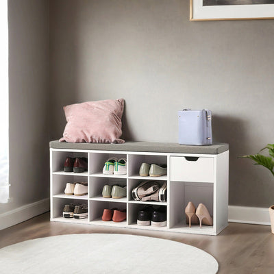 White entryway bench styled in a hallway with shoes stored in the cubbies