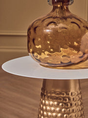 Side table styled with a drink and a book in a neutral living room
