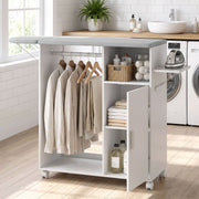 Ironing board cabinet in a laundry room with hanging shirts, folded towels and an iron on the side rack