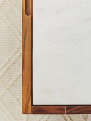White marble top acacia wood sideboard in a lifestyle living room setting