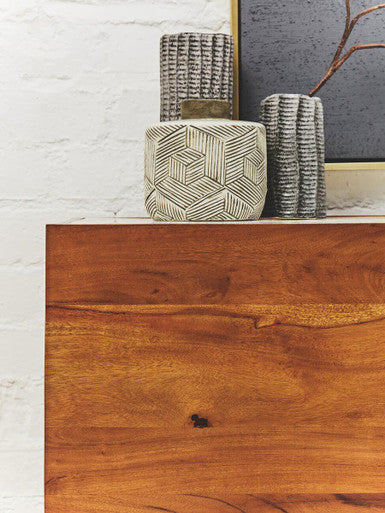White marble top acacia wood sideboard in a lifestyle living room setting