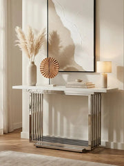 White marble console table styled in a hallway beneath a mirror