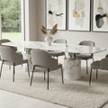 White marble dining table with cylindrical legs styled in a dining room setting