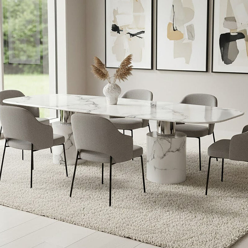 White marble dining table with cylindrical legs styled in a dining room setting