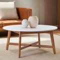 White marble round coffee table with acacia wood legs, 95cm diameter, on a plain studio background