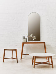 White marble round table pictured beside a large sectional sofa