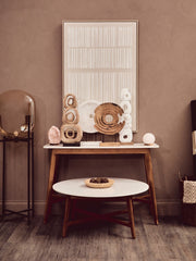 Round marble coffee table styled with a low bowl and stacked books