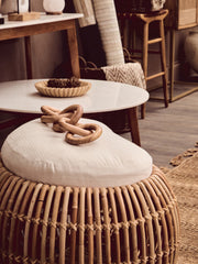 Round marble coffee table shown in a modern lounge setting