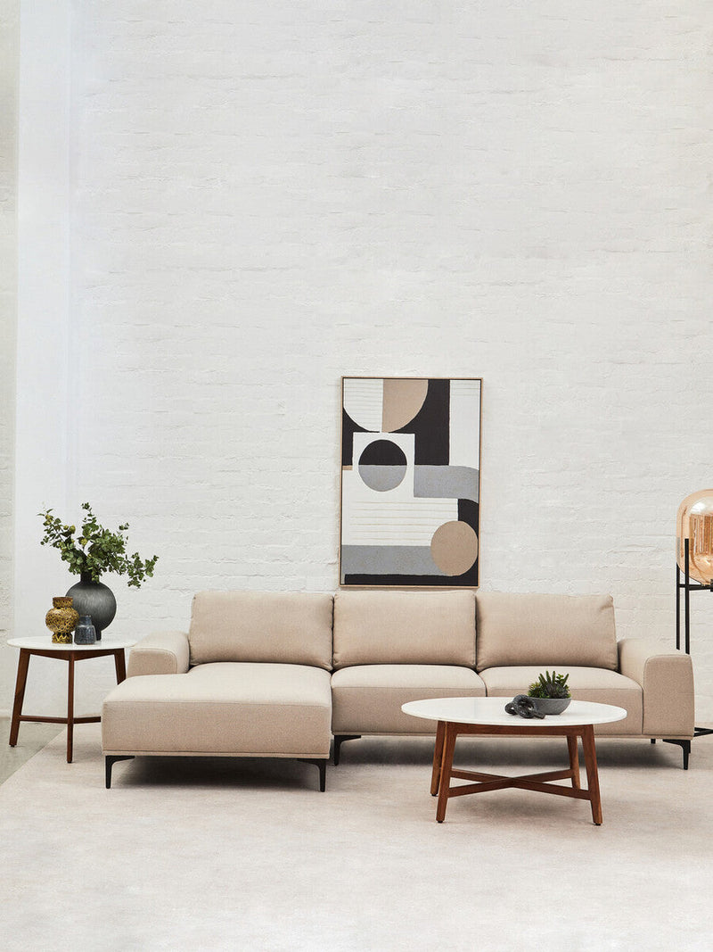 Marble top coffee table styled with a tray and ceramics in a living room