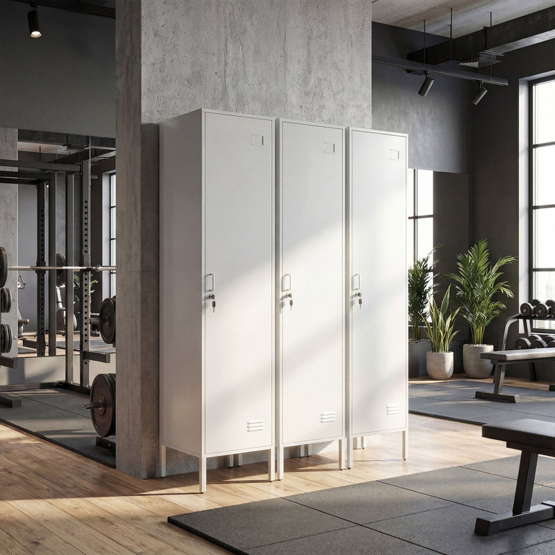 Row of three white lockers in a gym